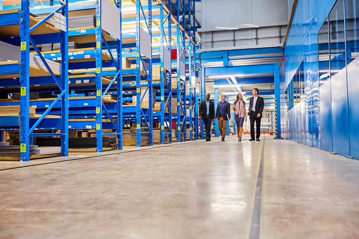 Business team walking together in warehouse